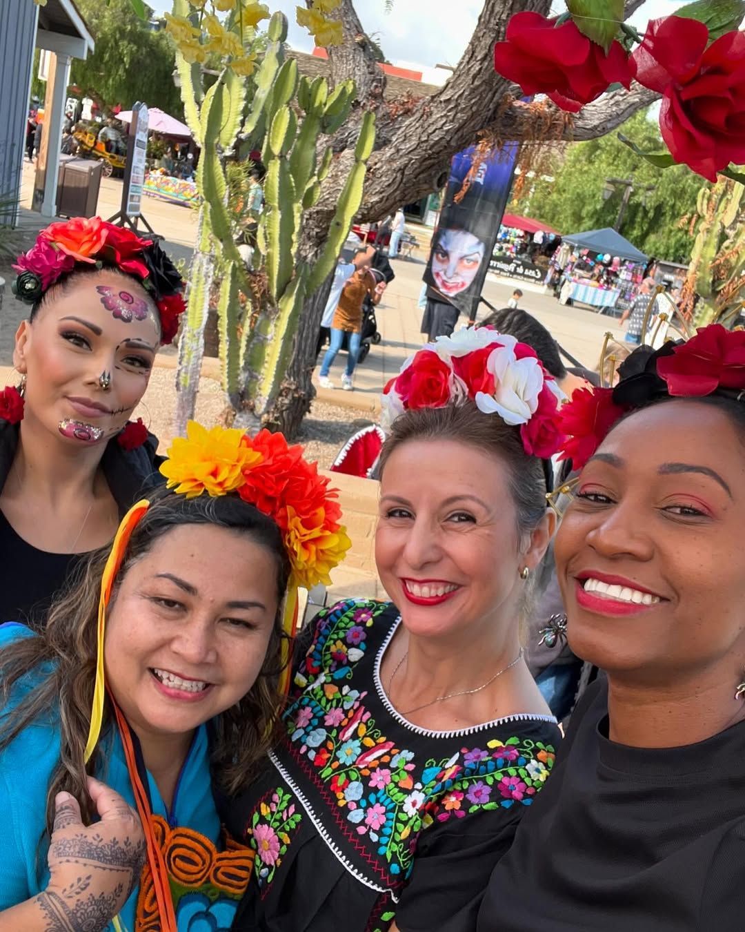 A group of women are posing for a picture with flowers in their hair.