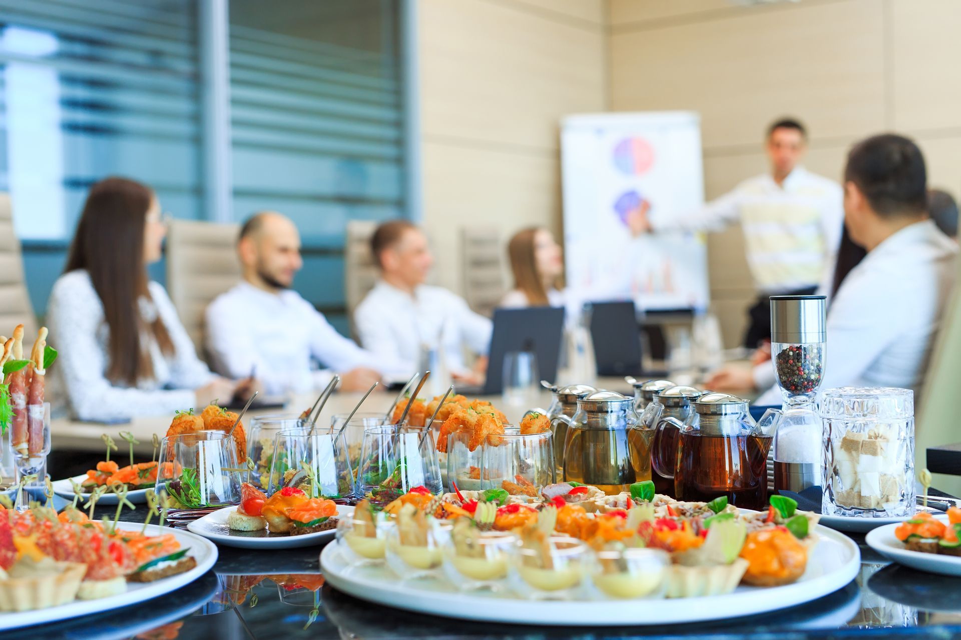A group of people are sitting around a table with plates of food.