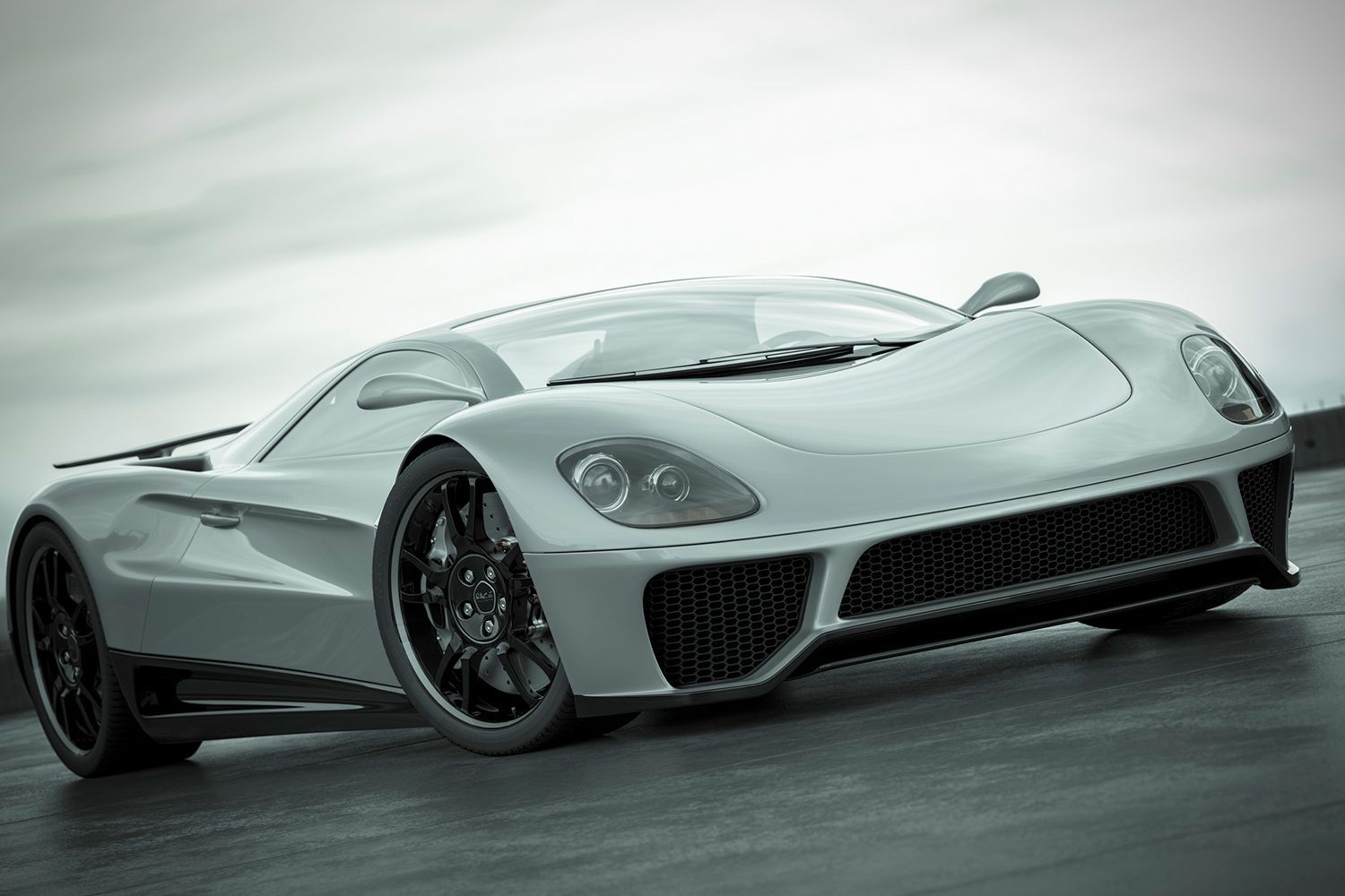 A white sports car is parked on the side of the road.