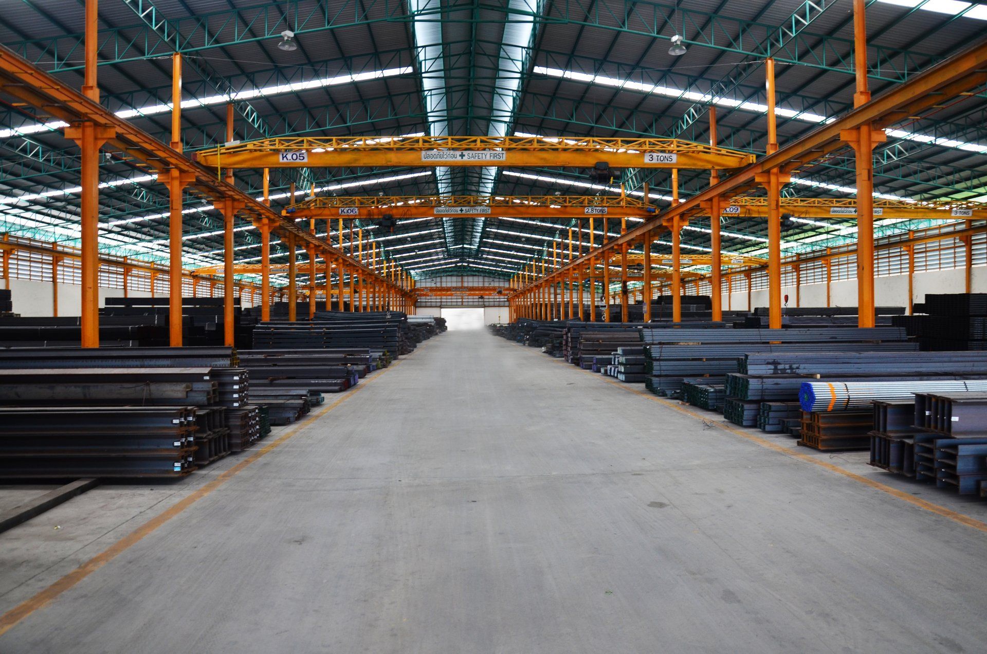 a large warehouse filled with lots of steel tubes .
