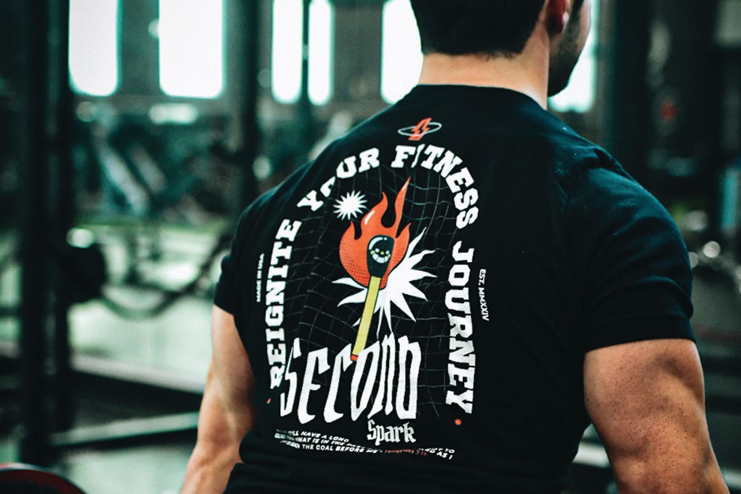 a man is wearing a black t-shirt with the words `` second journey '' on the back .