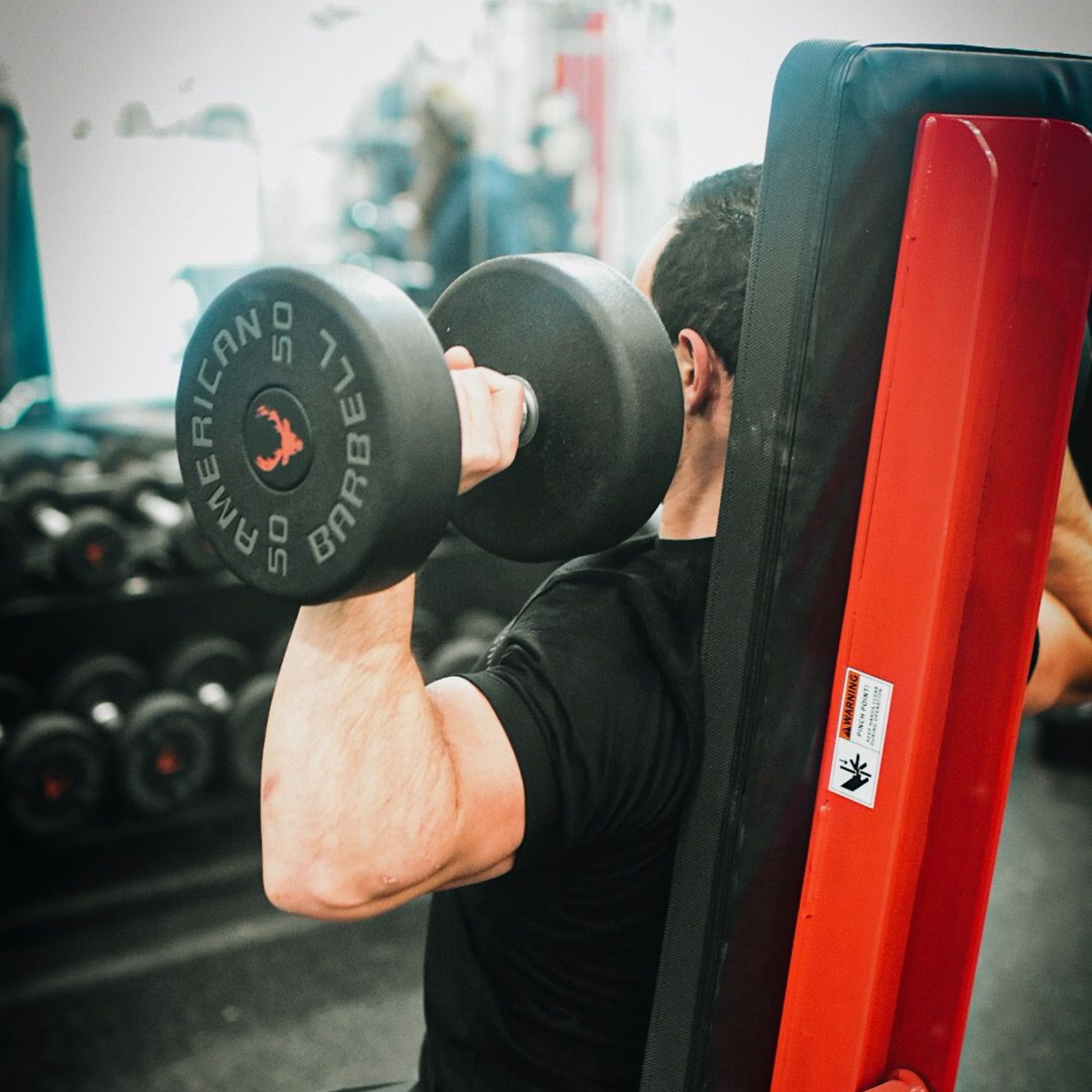 Golfer swinging club on green course with Credit Suisse signage behind him.