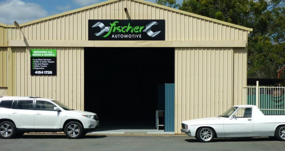 Tan Metal Auto Shop With Sign, Open Garage Door — Fischer Automotive in Svensson Heights, QLD