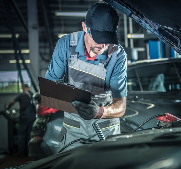 Mechanic in Overalls Inspecting a Car — Fischer Automotive in Svensson Heights, QLD