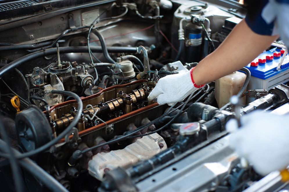 Mechanic in White Gloves Working on Exposed Car Engine — Fischer Automotive in Svensson Heights, QLD
