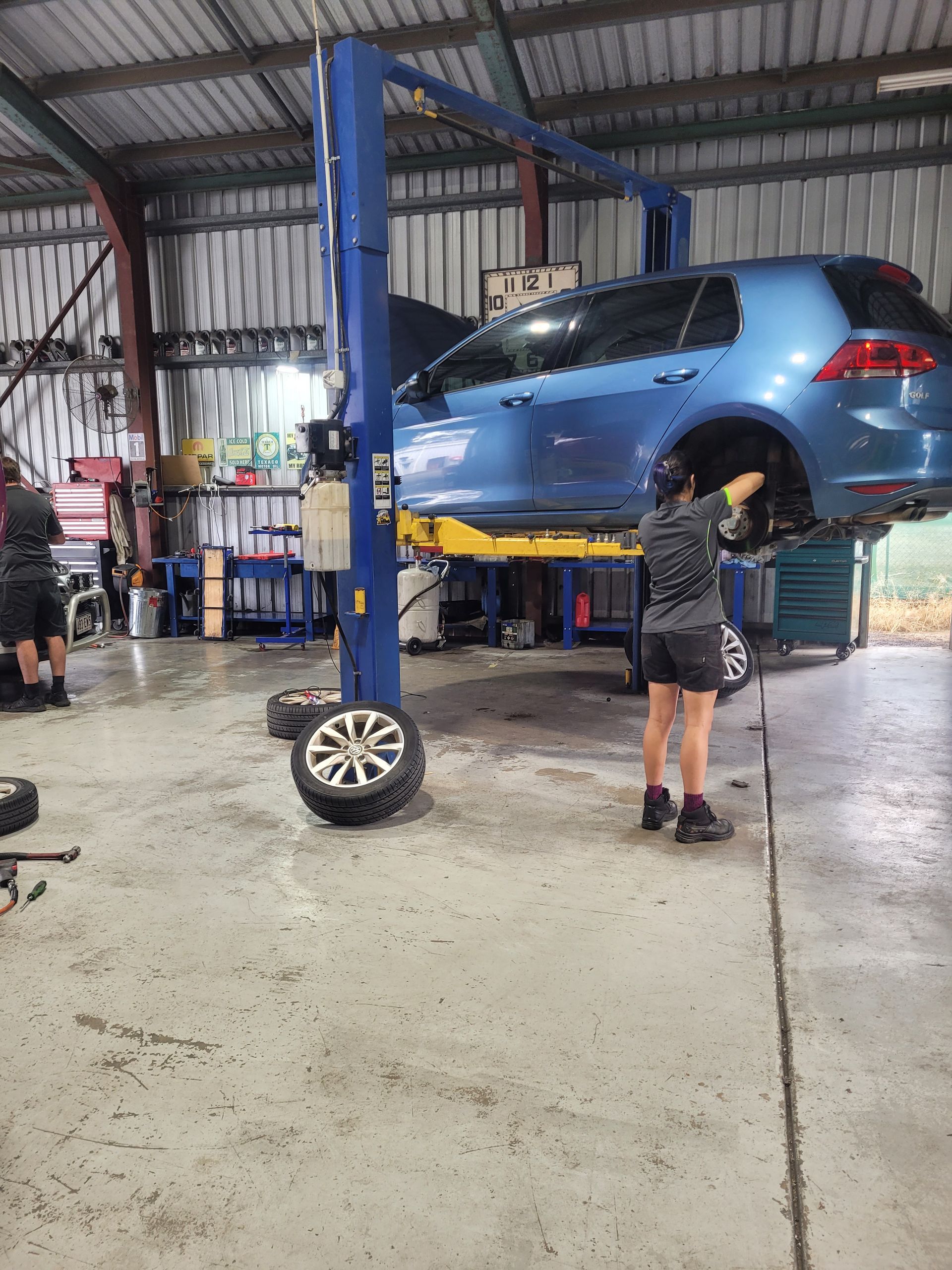 Blue Car Raised on a Lift in an Auto Repair Shop — Fischer Automotive in Svensson Heights, QLD