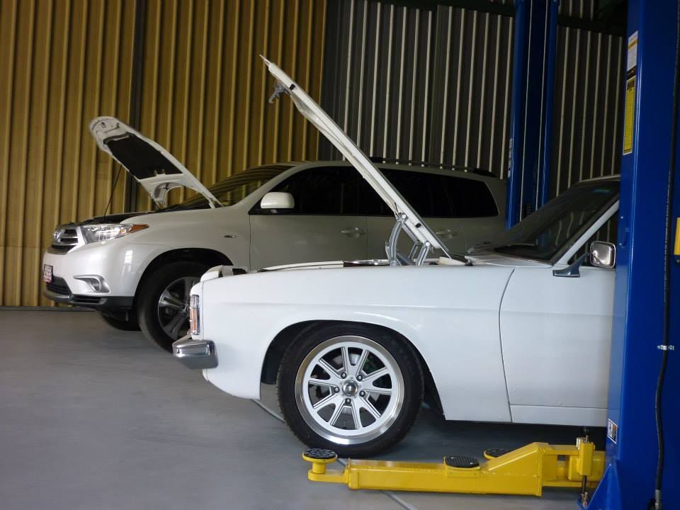 Two Cars in a Garage With Their Hoods Open — Fischer Automotive in Svensson Heights, QLD
