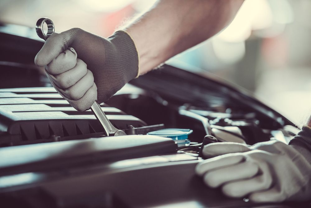 Mechanic Using a Wrench to Repair a Car Engine — Fischer Automotive in Svensson Heights, QLD
