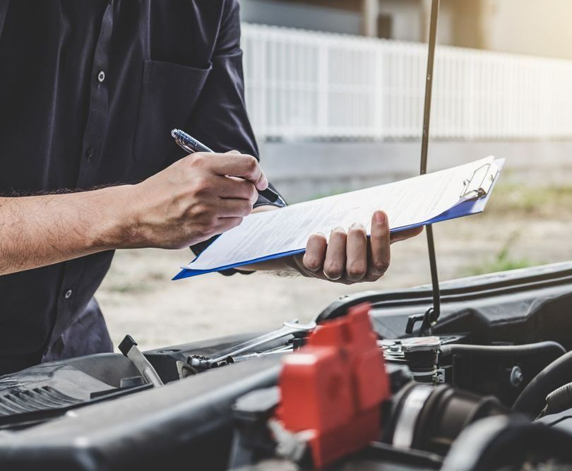 Mechanic Writing on a Clipboard — Fischer Automotive in Svensson Heights, QLD