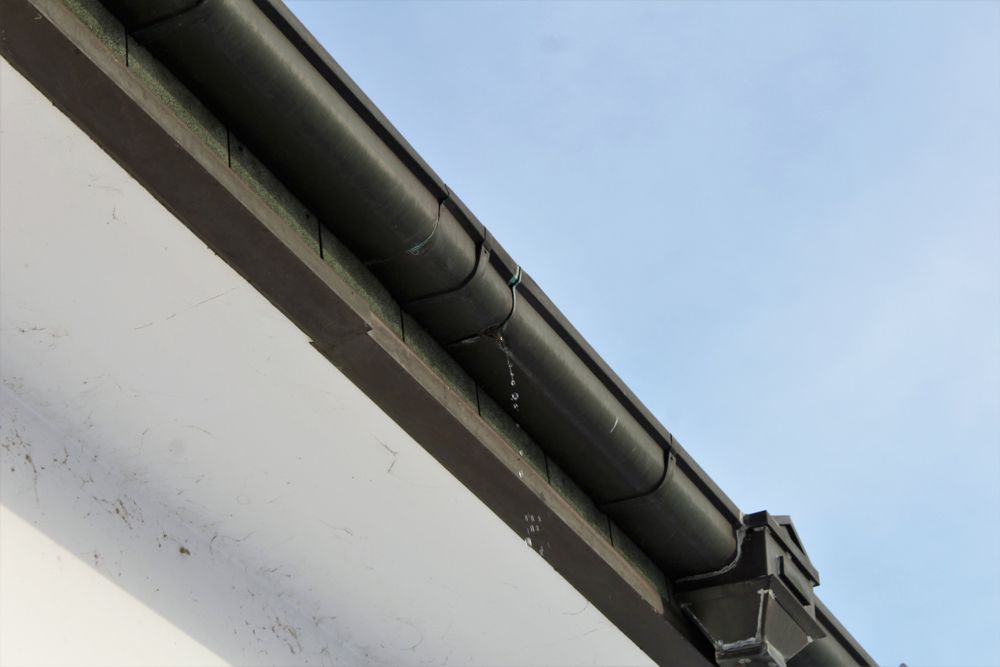 A Close Up of a Gutter on the Side of a Building — RJT Roofing In Bonner, ACT