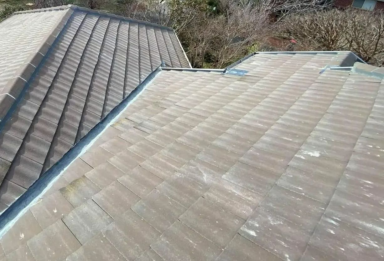 A Roof With a Lot of Tiles on It and Trees in the Background — RJT Roofing In Bonner, ACT