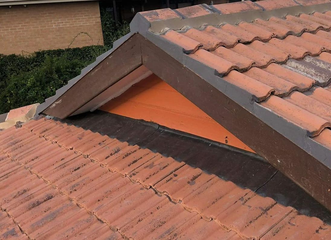 A Roof With a Triangle in the Middle of It — RJT Roofing In Bonner, ACT