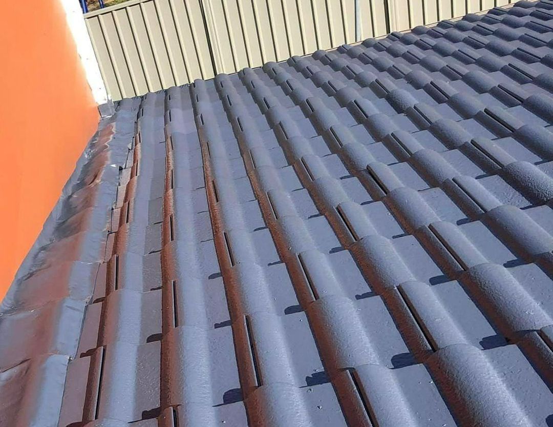 A Close Up of a Roof With a Fence in the Background — RJT Roofing In Bonner, ACT