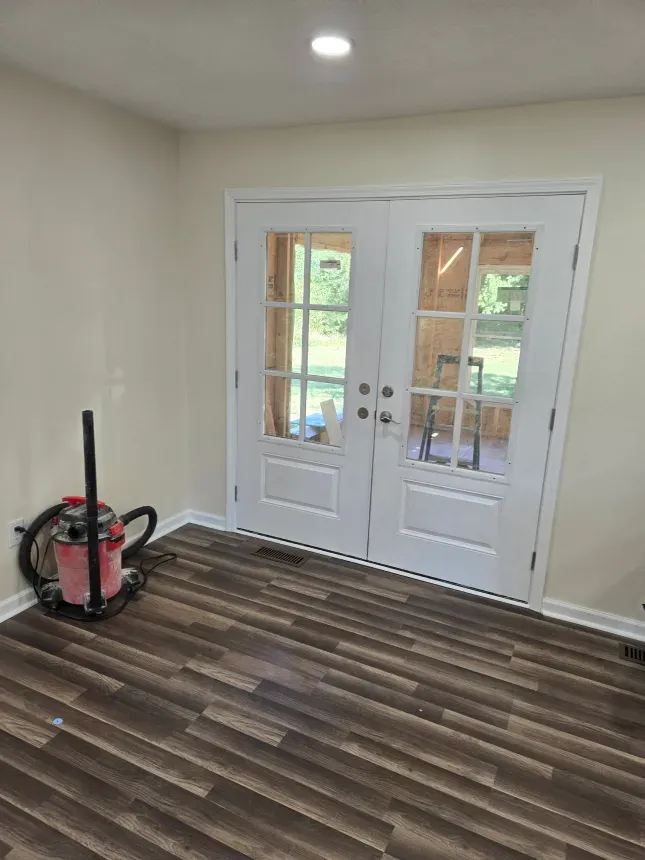 There is a vacuum cleaner in the middle of the room.