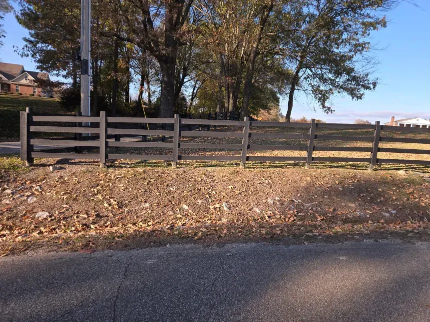 A wooden fence along the side of a road
