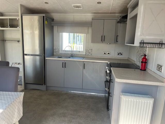 The spacious kitchen within a 2 bedroom holiday home for sale at Cotswold Grange Country Park