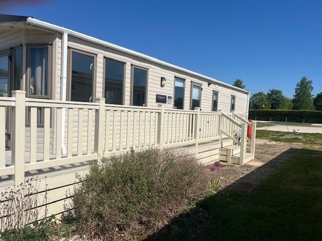 Exterior side view of a 2 bedroom holiday home for sale at Cotswold Grange Country Park