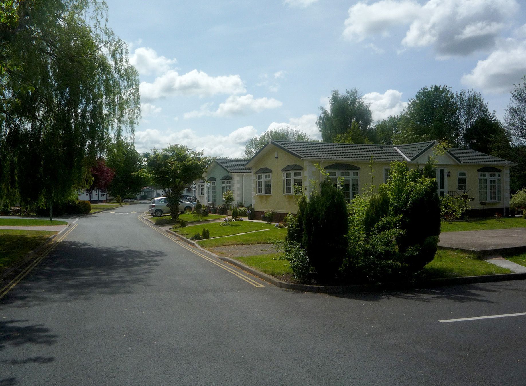A row of houses are lined up on the side of a road.