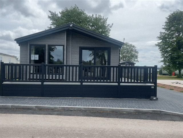 External view of the beautiful Portland Lodge for sale at Cotswold Grange Country Park