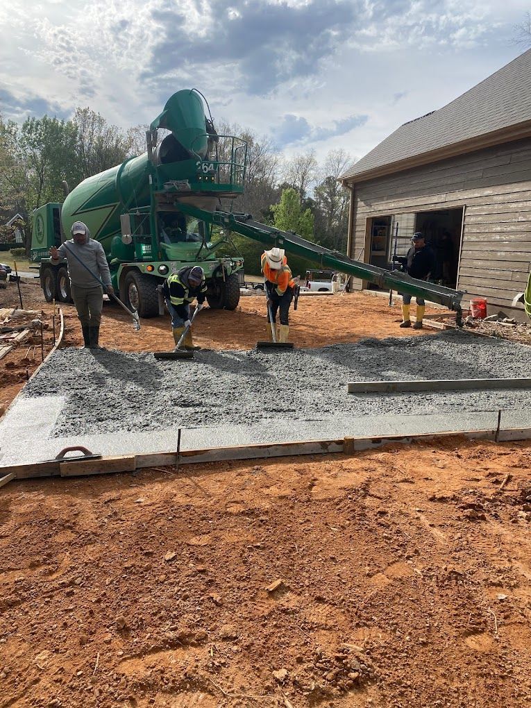 A concrete mixer is being used to pour concrete into a foundation.