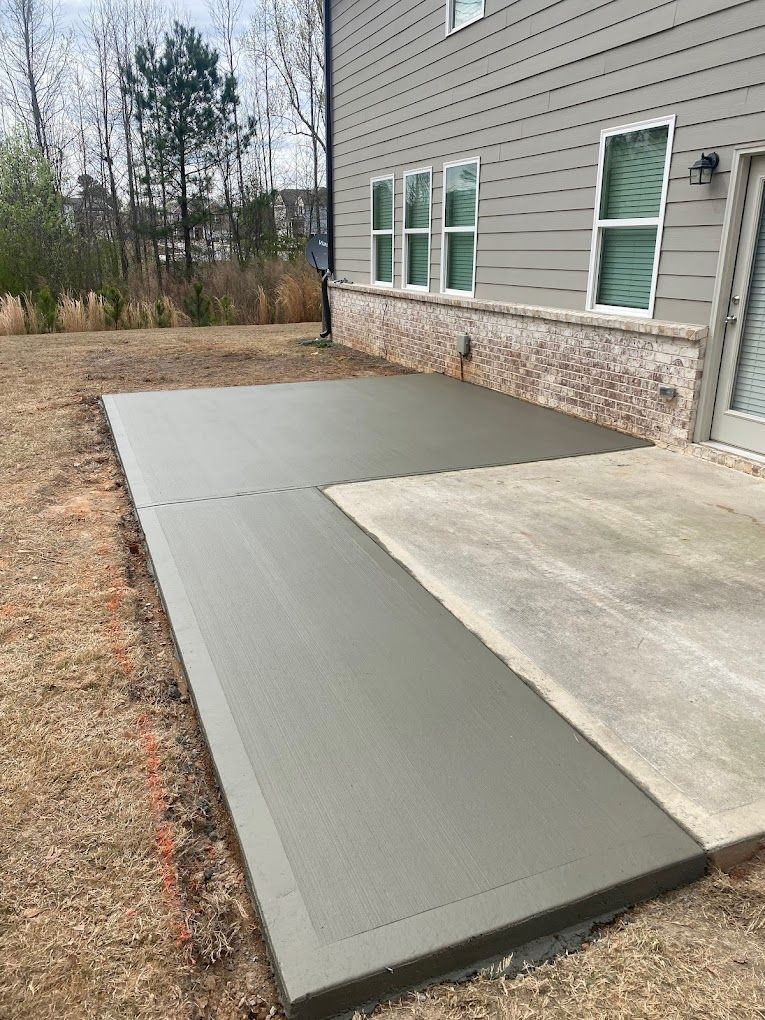 A concrete walkway is being built in front of a house.