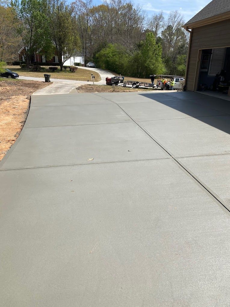 A concrete driveway is being built in front of a house.