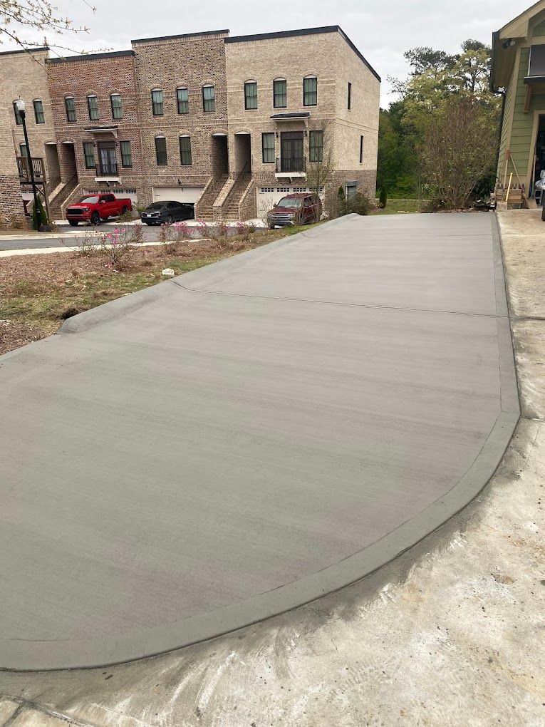 A concrete driveway is being built in front of a building.
