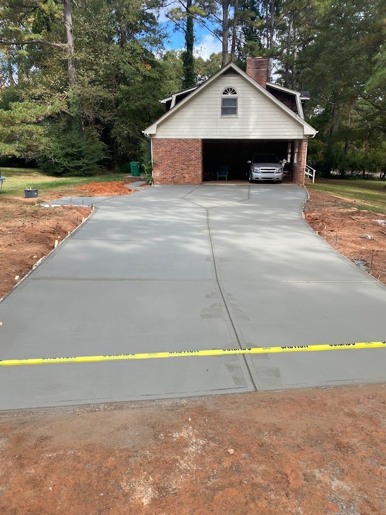 A car is parked in a driveway in front of a house.