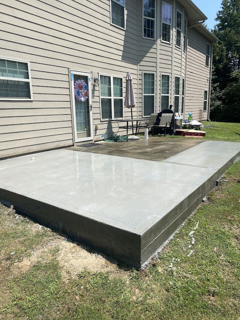 A large concrete patio in front of a house.