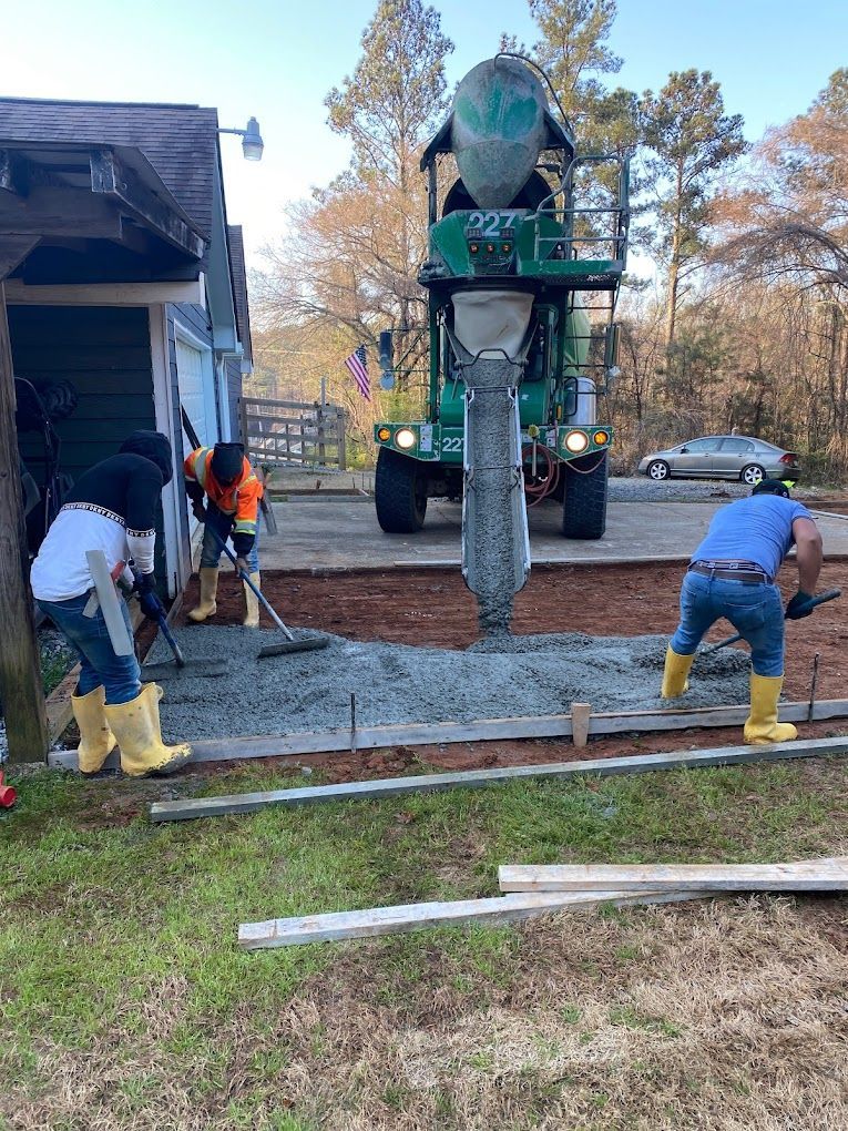 A group of construction workers are working on a driveway.