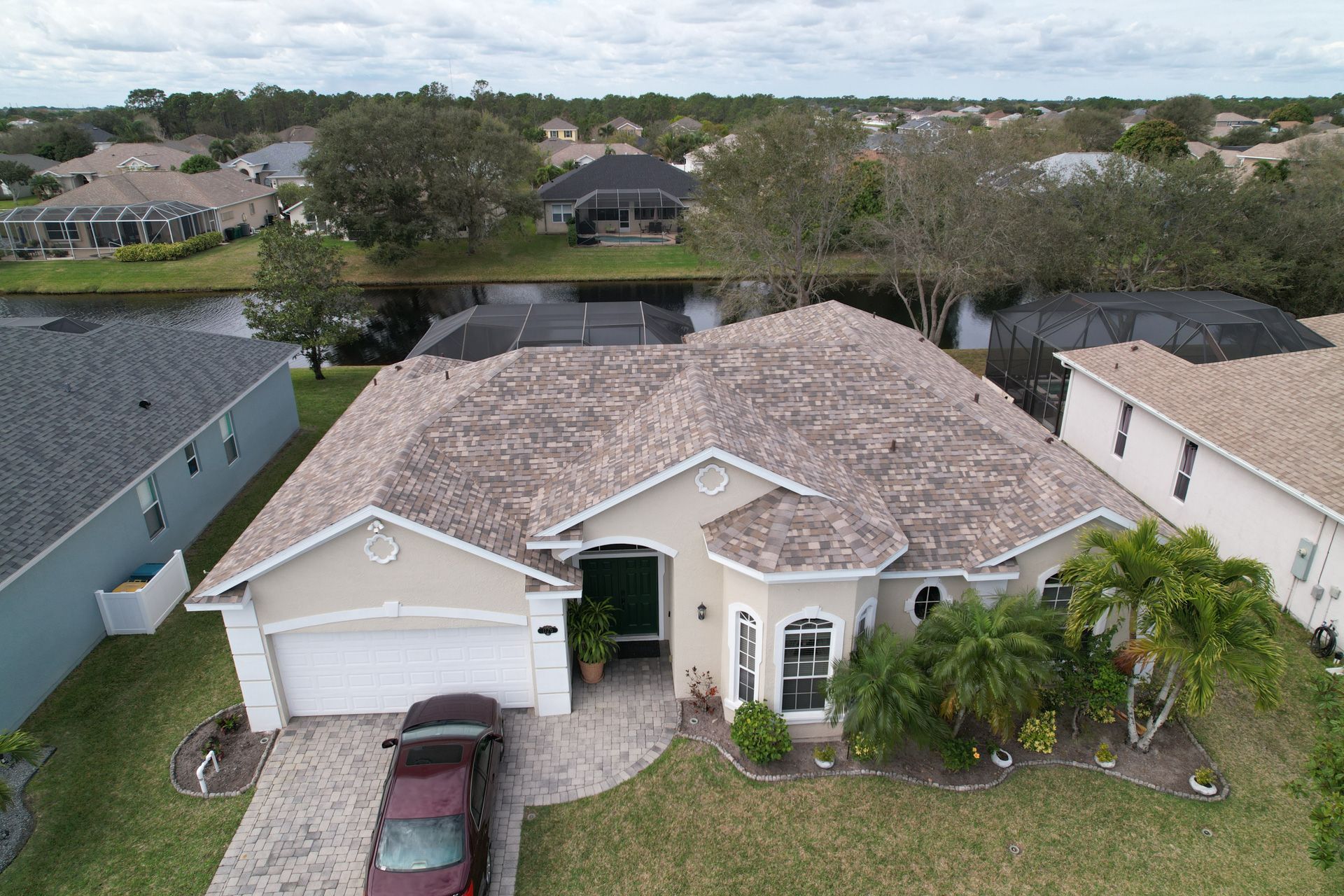an aerial view of a house with a car parked in front of it .