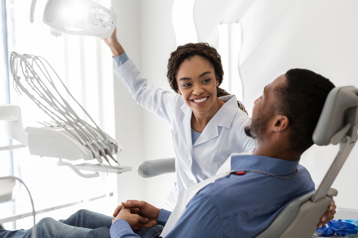 a model of a dental implant is sitting on a table next to other models of teeth .