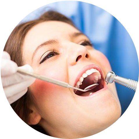 Dentist Checking Patient's Teeth — Cary & Garner, NC — Cusumano Oral Surgery & Implant Center