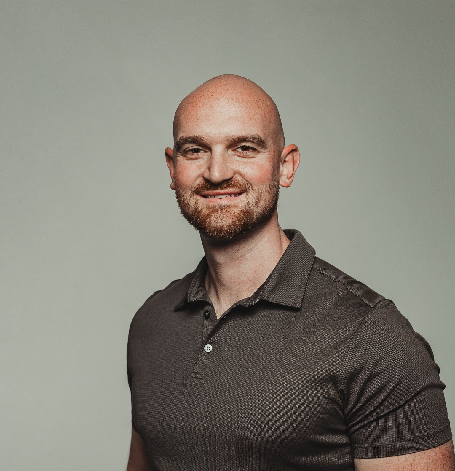 A man with a beard wearing a black baseball cap