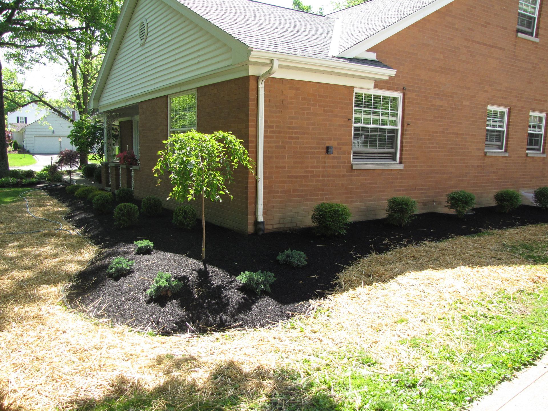 A house with a gravel garden in front of it.