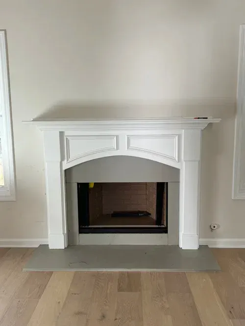 There is a fireplace in the middle of the room.