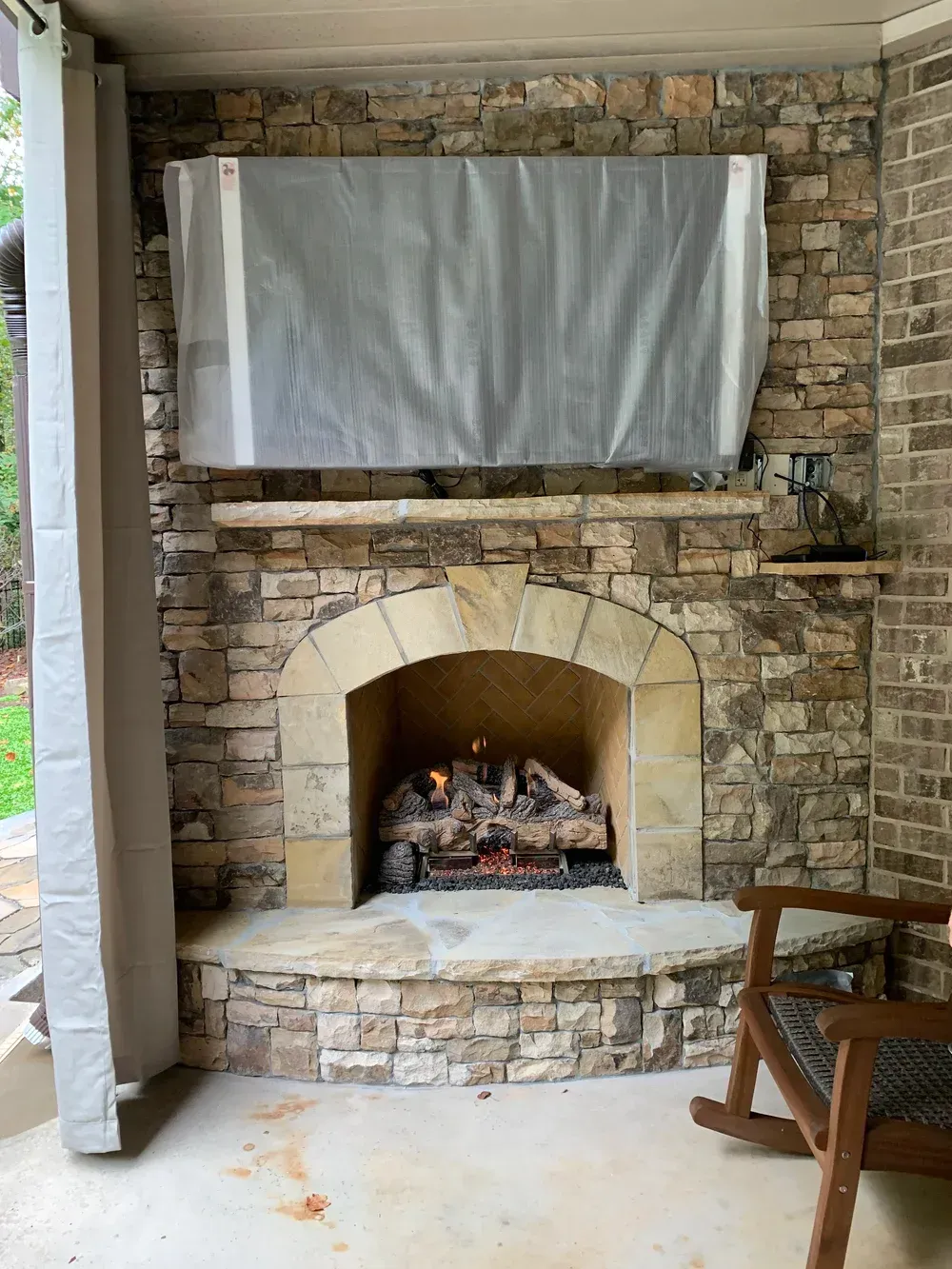 A white brick fireplace with a flat screen tv above it.