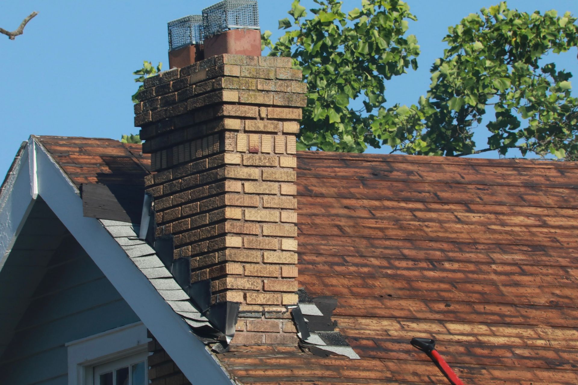 A brick chimney on the roof of a house