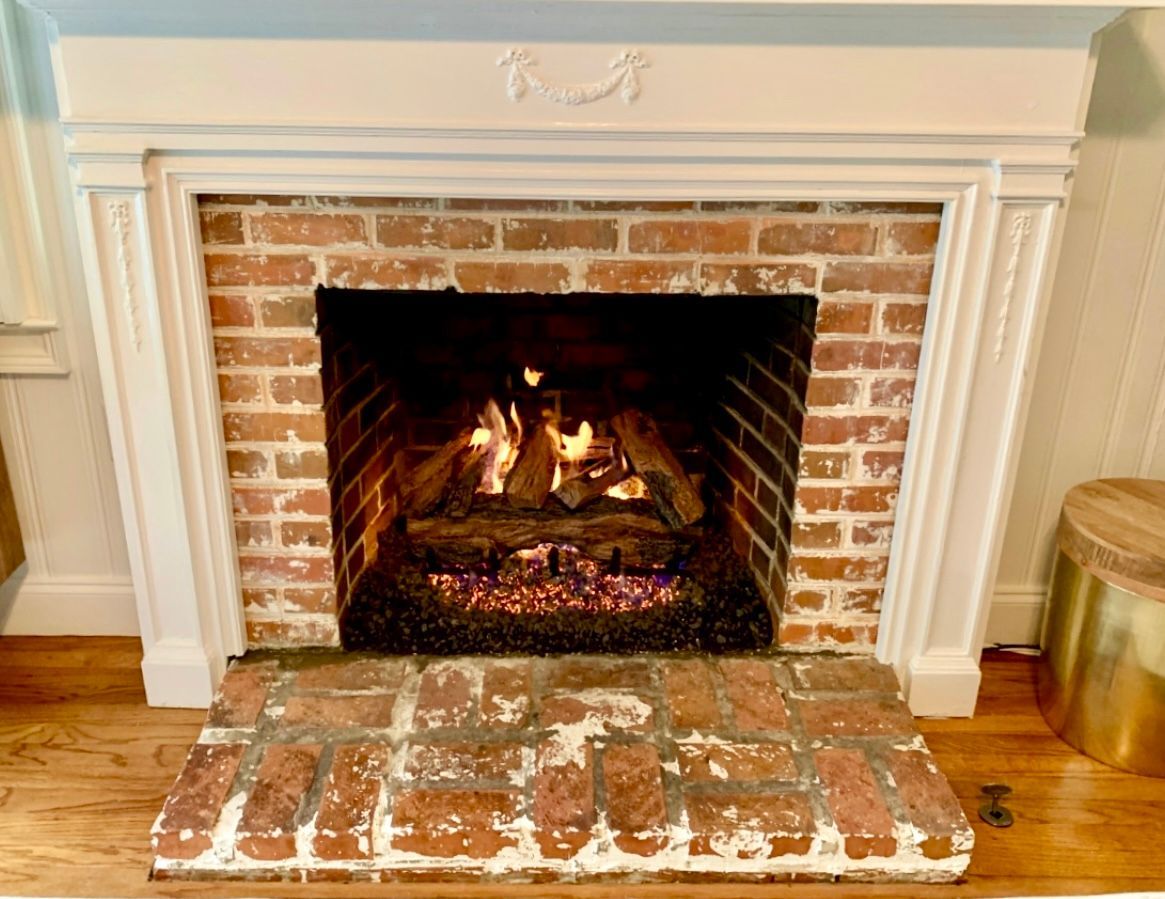 A bathroom with two sinks , a walk in shower and two mirrors.