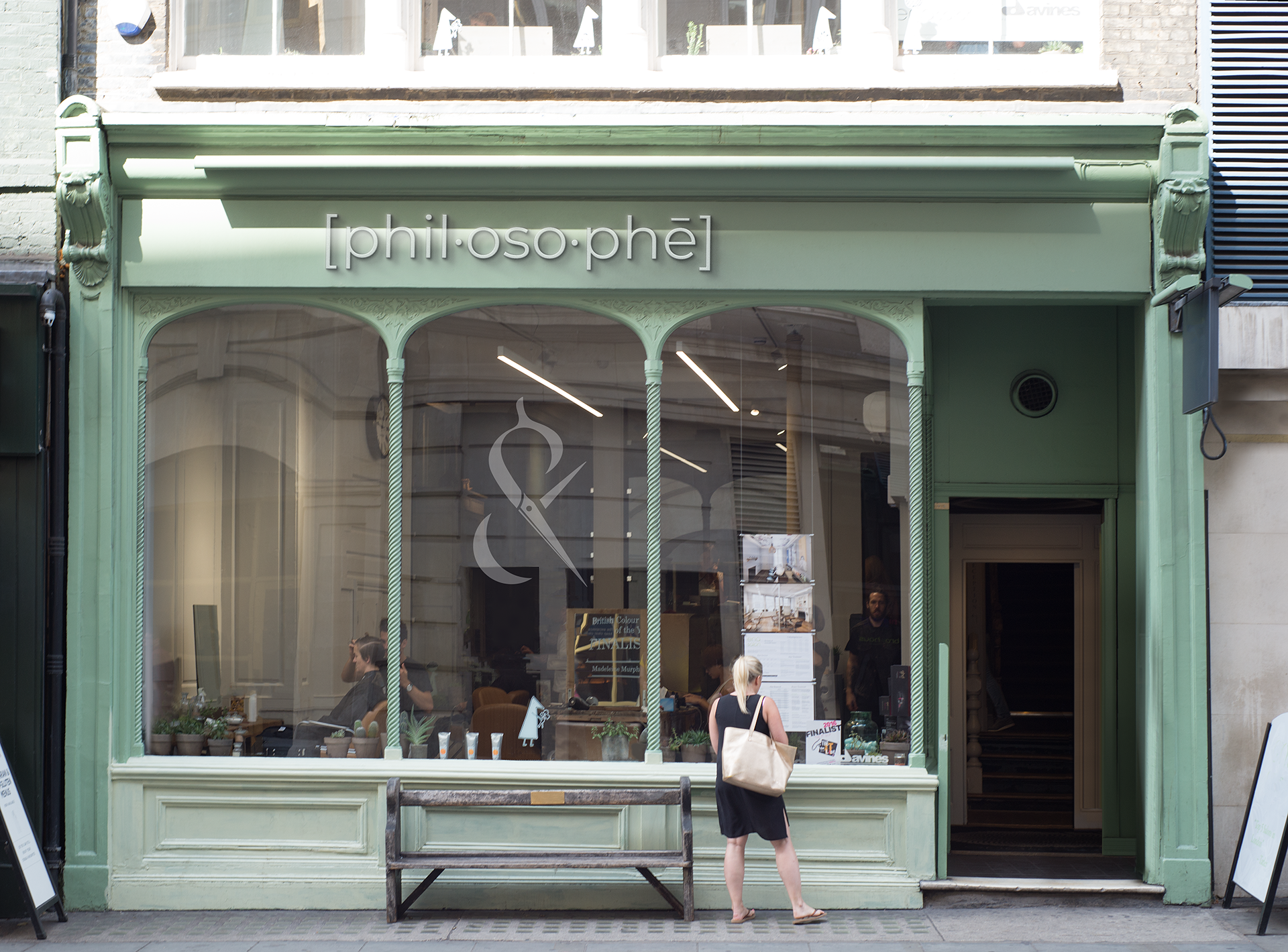 Green storefront with glass windows,