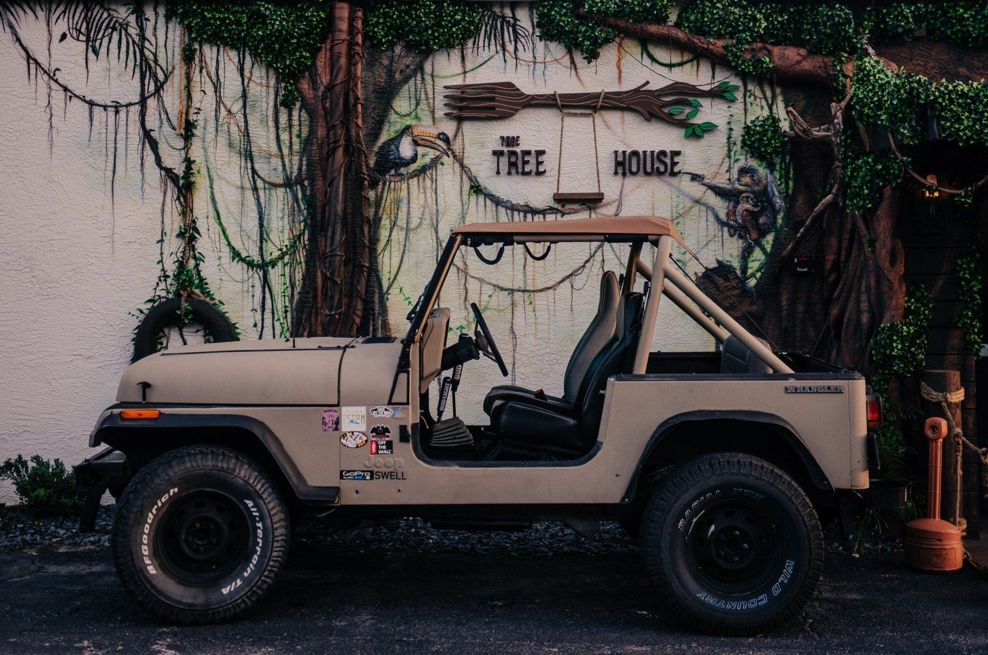 Tan Jeep parked outside 