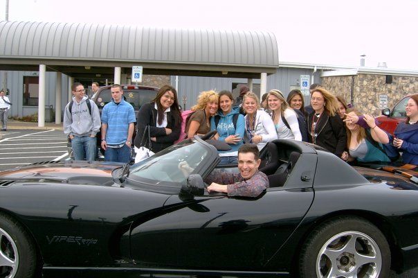 Paul with some of his students. This Dodge Viper is on loan to the school!