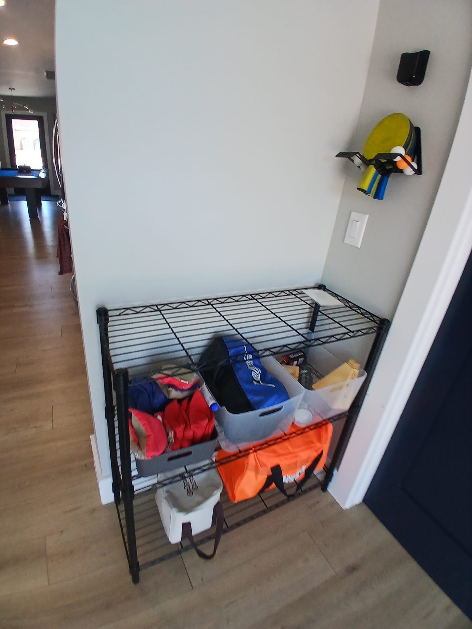 A shelf with a lot of items on it in a hallway.