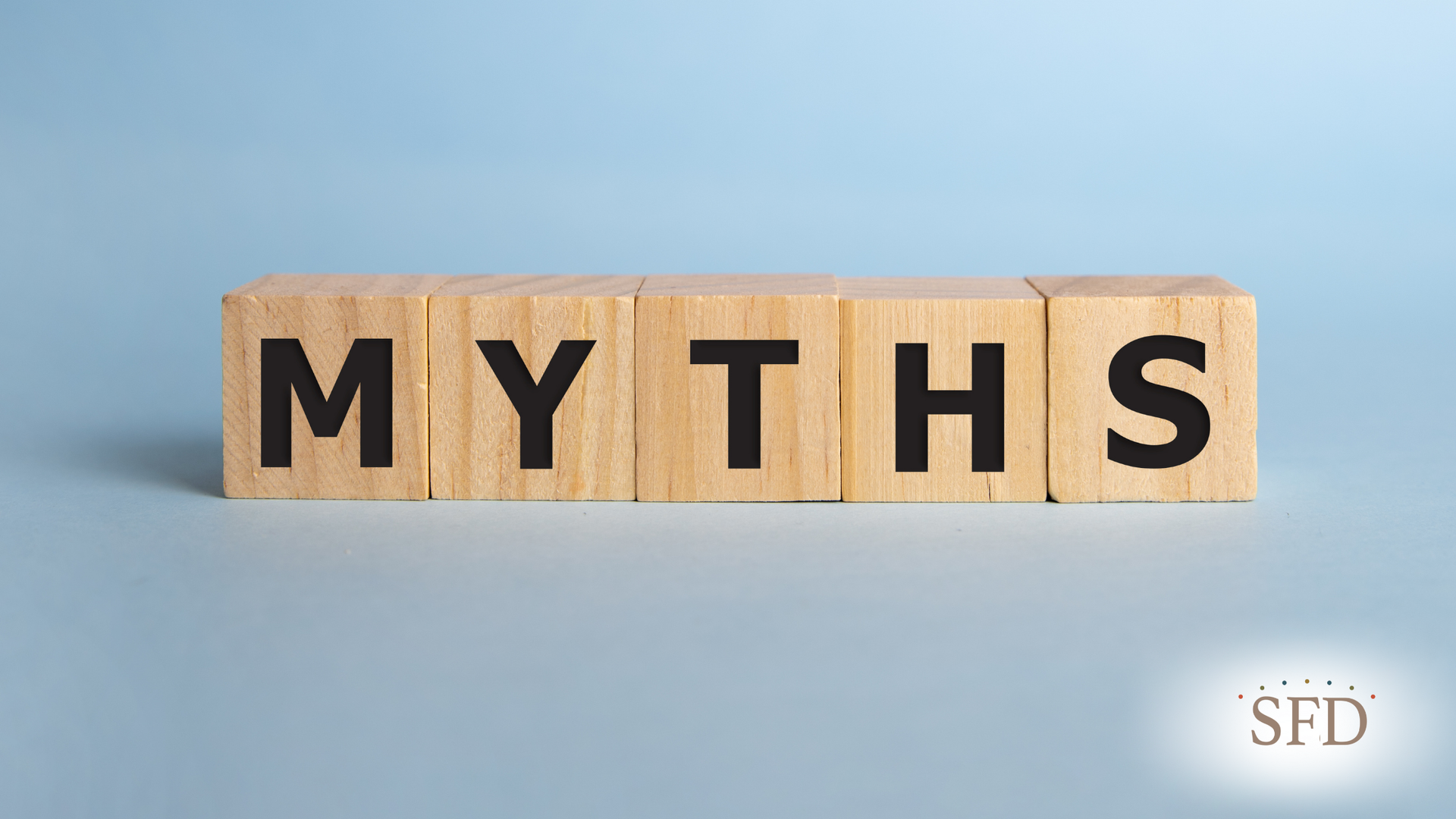 The word myths is written on wooden blocks on a blue background.