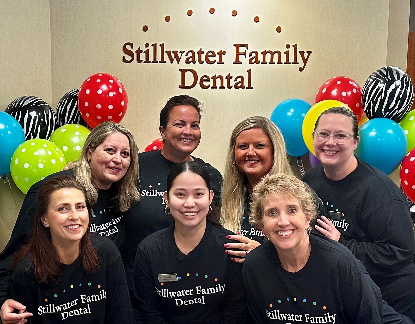 A group of women are posing for a picture at stillwater family dental