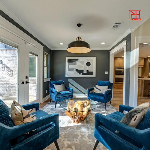 Cozy, stylish sitting area with blue velvet chairs and a unique wood table. Perfect home staging by PH Realty.