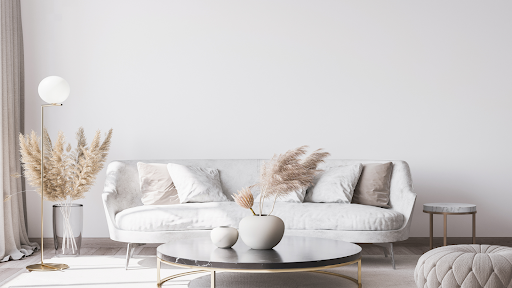 A living room with a couch , coffee table , and lamp.