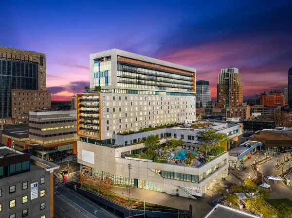 An aerial view of a large building in the middle of a city at night.