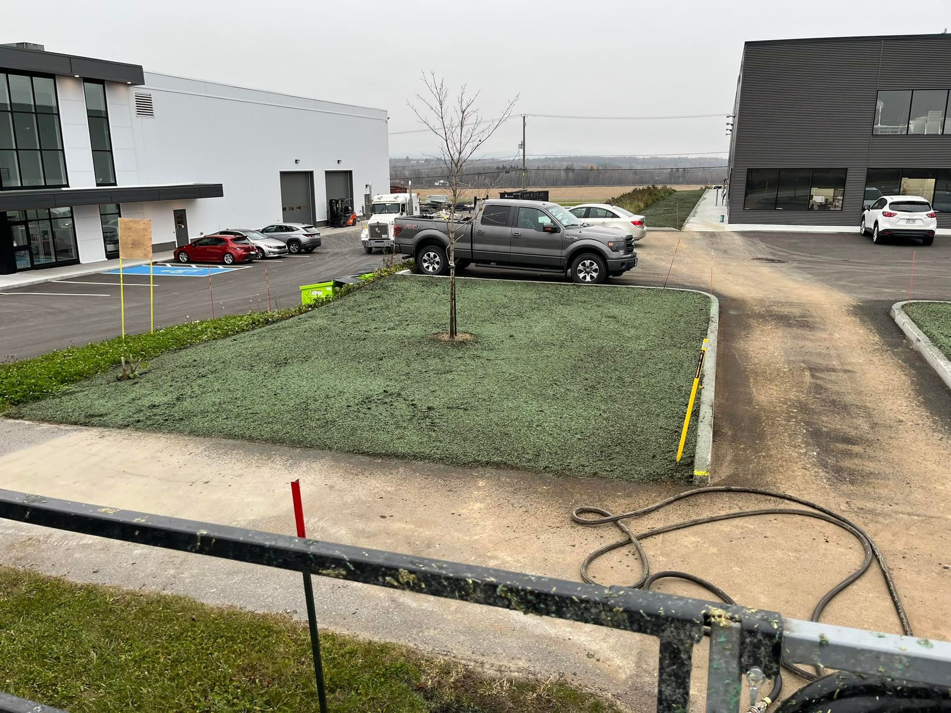 Un camion est garé sur un parking à côté d'un bâtiment.