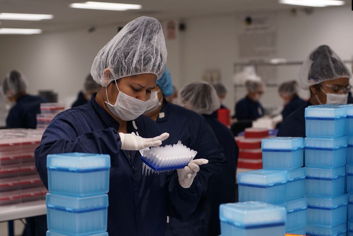 A woman wearing a mask and gloves